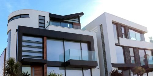 Contemporary luxury home with glass balconies in Poole, UK, showcasing modern architectural design.