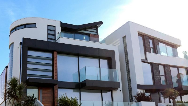 Contemporary luxury home with glass balconies in Poole, UK, showcasing modern architectural design.